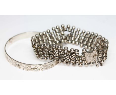 A Victorian white metal bracelet and a hallmarked silver bangle, wt. 44.68g.  