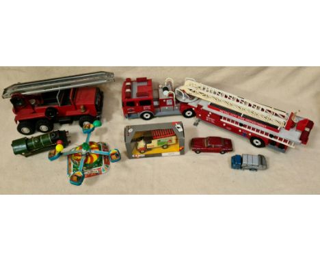 A box of vintage toys to include a tin merry go round, Budgie truck, Corgi car, Funrise fire truck, Meccano fire truck, Corgi