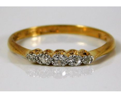 An 18ct gold ring set with five small old cut diamonds 1.6g size N