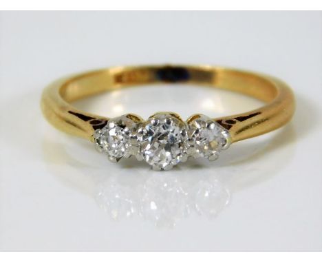 An 18ct gold ring set with three diamonds of approx 0.45ct 2.6g size L