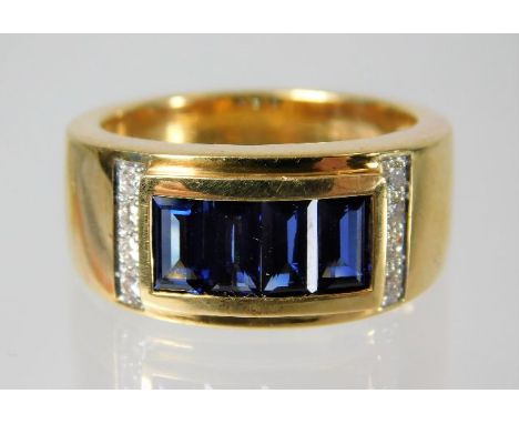 An 18ct gold ring set with diamonds and baguette cut sapphires