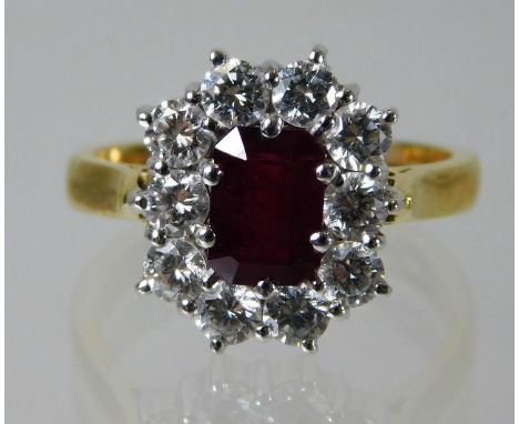 An 18ct gold ring set with approx 1ct of diamonds and a ruby 6.8g Size O