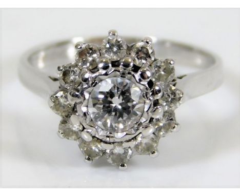 An 18ct white gold ring set with approx 1ct of diamonds, the centre stone being 0.5ct 3g Size J