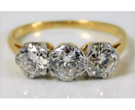 A yellow metal trilogy ring, tests as 18ct gold, with platinum mount, set with three diamonds of approx. 1.5ct
