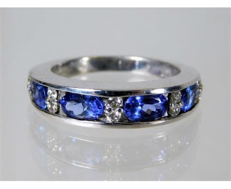 An 18ct gold ring set with tanzanite and 0.2ct diamond  6.3g Size P