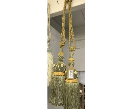 One pair of green with gold embellishment curtain tie backs with tassels