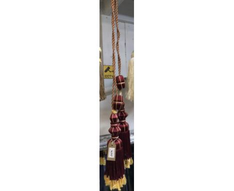 One pair of red wine and gold curtain tie backs with tassels