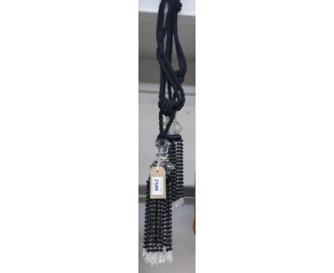 One pair of black curtain tie backs with beaded tassels and gems
