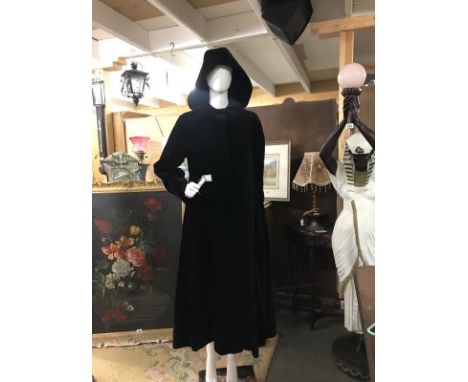 A Lovely quality black full length velvet coat with hood. Hidden button placket. Designer Four Seasons London