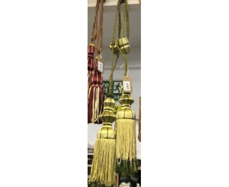 One pair of green with gold embellishment curtain tie backs with tassels
