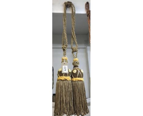 Brown and gold curtain tie backs with tassels