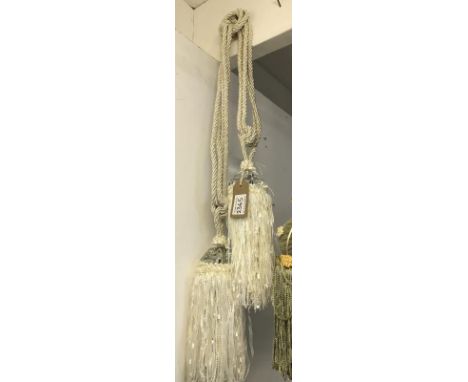 One pair of cream curtain tie backs with tassels