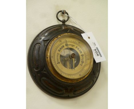 Early 20th century aneroid barometer in carved oak case, D16cm