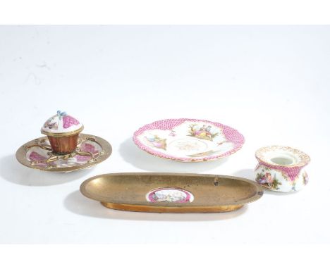 A 19th century inkwell and saucer, baring Meissen marks, with panels depicting landscapes intersected with pink fish scale pa