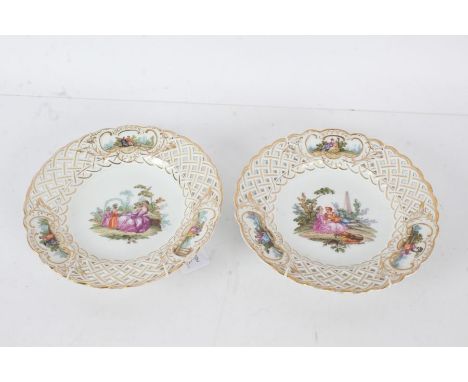 Pair of Meissen porcelain cabinet plates, the first painted with a courting couple, the second with ladies in a garden settin