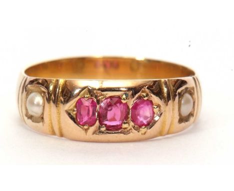 An antique ruby and seed pearl ring centering three graduated rubies between two small seed pearls (unmarked), size K/L