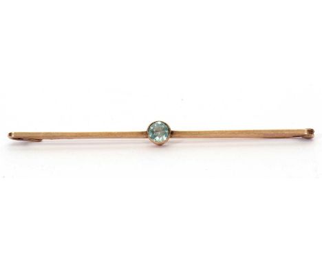 Vintage aquamarine brooch centering a round faceted aquamarine on a plain polished bar, stamped 9ct, 7cm long