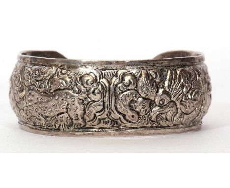 Metal torque bangle decorated with dragons and scrolls etc