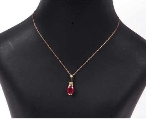 Ruby and diamond pendant, the oval faceted ruby is 1.35ct approx, highlighted above with two small round brilliant cut diamon
