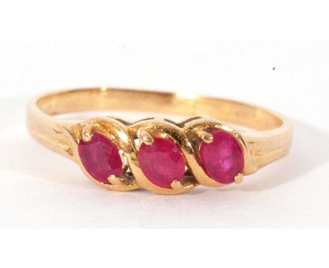 Modern three stone ruby ring featuring three faceted oval shaped rubies, size M