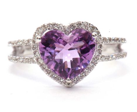 Modern 19ct white gold amethyst and diamond ring, the heart shaped faceted amethyst set within a small diamond surround betwe