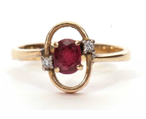 Modern ruby and diamond ring, the oval faceted ruby in an oval halo surround highlighted with two small diamonds, stamped 585