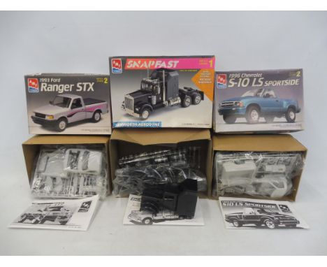 Three boxed 1:25 scale AMT plastic model kits, contents unchecked, but appear sealed, including a 1996 Chevy S10.