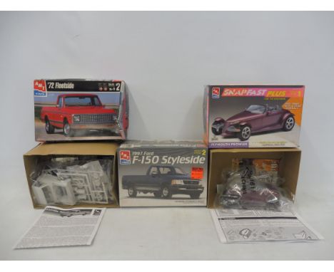 Three boxed 1:25 scale AMT plastic model kits, contents unchecked, but appear sealed, Plymouth Prowler and two others.