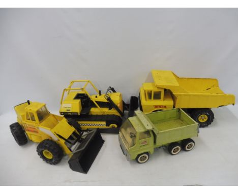 Four large scale original Tonka construction vehicles.