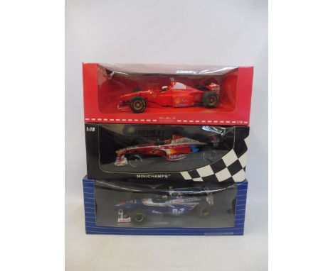 Three boxed 1:18 scale model F1 racing cars, including Williams Minichamp. 