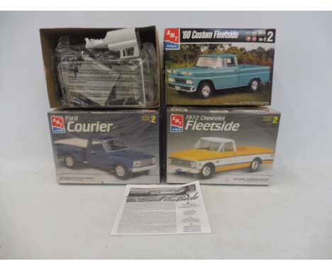 Three boxed 1:25 scale AMT plastic model kits, contents unchecked, but appear sealed, to include a 1960s custom fleet sign.