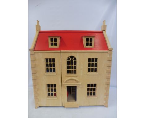 A large scale wooden dolls house, with some accessories.