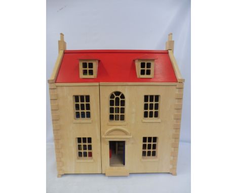 A large scale wooden dolls house, with some accessories.