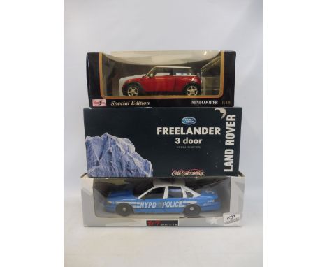 Three 1:18 scale models, to include the Mini Cooper, Land Rover Freelander etc.