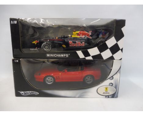 A 1/18 scale boxed Hot Wheels Ferrari plus a Minichamps Red Bull.