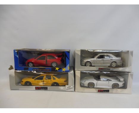 Four boxed 1/18 scale Ute models to include the Ford Escort Cosworth.