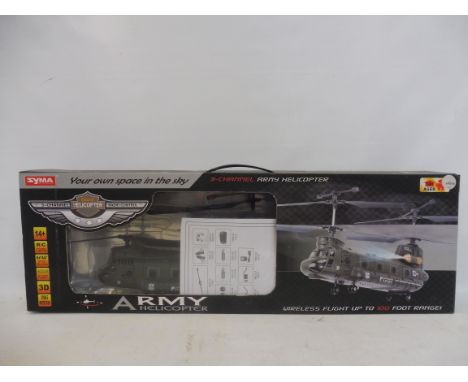 A boxed radio controlled Syma army Chinook helicopter.