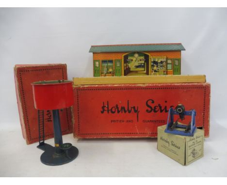 A boxed pre-war Hornby o gauge wayside station, water tank and buffer stops (with light).