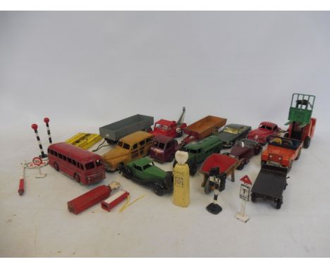15 Dinky and Corgi items, a car ramp, petrol pumps and road signs.