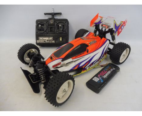 A Tamiya Rising Storm 1:10th scale remote controlled buggy, with a battery and Techiplus radio control.