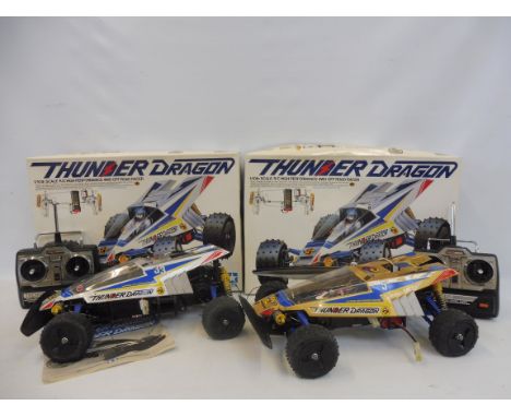 A boxed Tamiya Thunder Dragon 1/10th scale high performance 4WD off-road racer, model kit, plus one other and two controllers