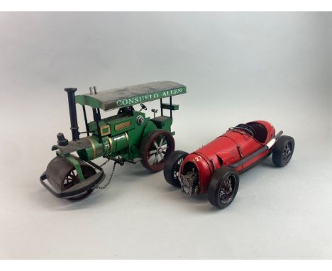 Two tin models, one of a steam roller and the other a 1930's racing car, steam roller size 32 x 18cm.
