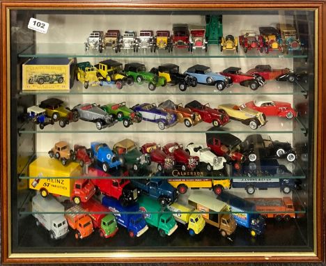 A display case containing diecast model vehicles including Matchbox, Yesteryear and Days Gone, 52.5 x 63.5cm.