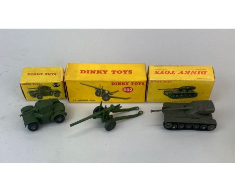 Three boxed Dinky Toys diecast model equipment: model no. 692, model no. 670, model no. 80C.