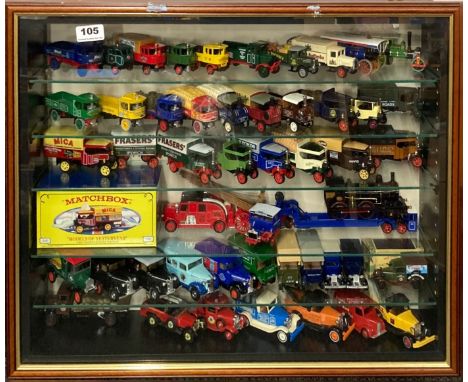 A display case containing diecast model vehicles including Matchbox and Yesteryear, 52.5 x 63.5cm.