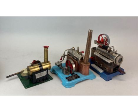 A Wilesco D14 static steam engine together with a Jensen MGF steam engine and a Bowman model static steam engine.