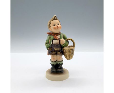 A matte hand painted figure of a boy carrying a basket with an astonished expression. Goebel backstamp. M.I. Hummel impressed