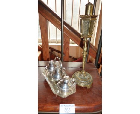 Brass table lighter in the form of a street lamp and a silver plated cruet set of miniature Guernsey milk cans
