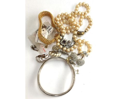 An unmarked bangle (tests as silver) 21.6g together with various items of jewellery and 5 dice; together with a small plated 