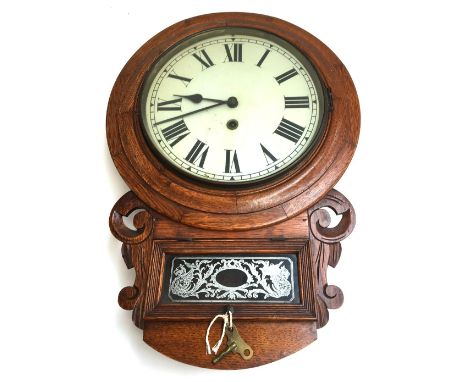 A late 19th/early 20th century oak cased wall clock, Roman numerals to dial, the movement inscribed 'Manufactured by the Brit
